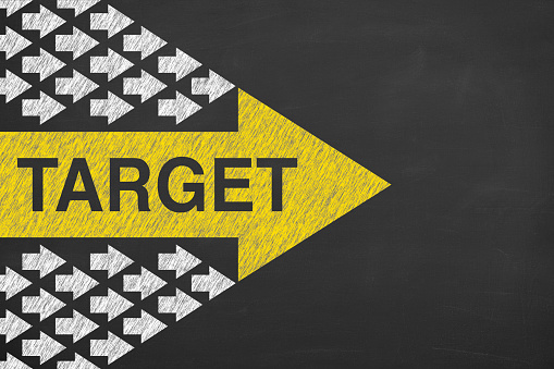 Target Concepts with Arrows on Chalkboard Background
