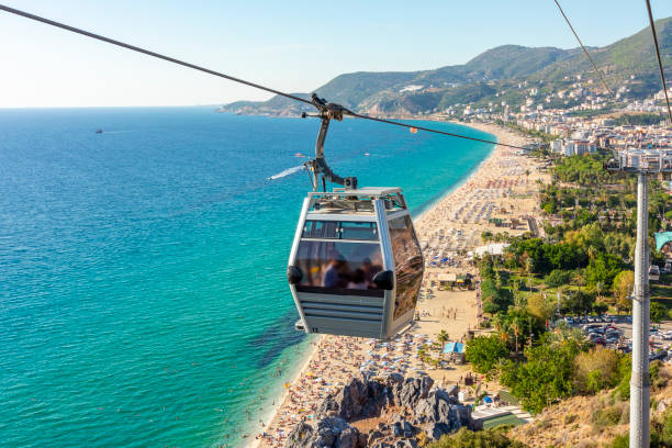 Cable car to fortress over Cleopatra beach in Alanya, Turkey Cable car to fortress over Cleopatra beach in Alanya, Turkey alanya stock pictures, royalty-free photos & images