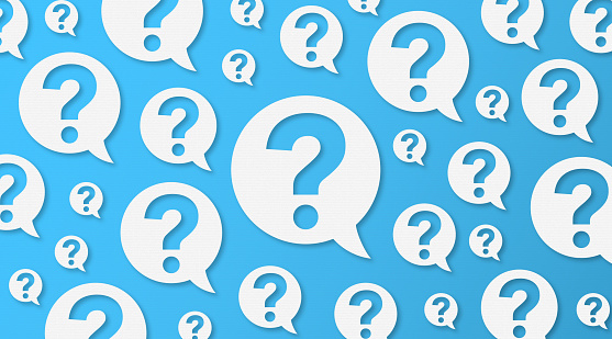 Question Mark and Speech Bubbles with Copy Space On Blue Cardboard Background