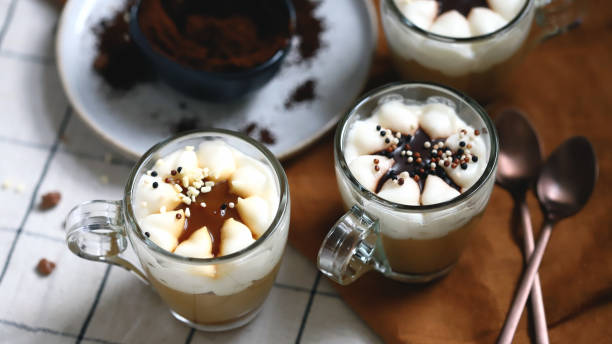 istock Small mugs with a three-layer coffee-caramel dessert. Delicious pudding in glass cups. 1439547565