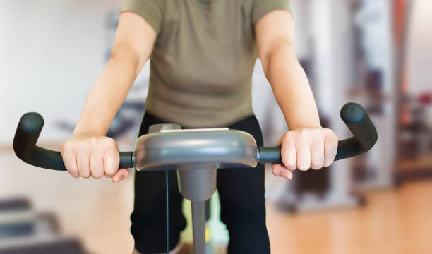 istock woman using an exercise bike 1439550619