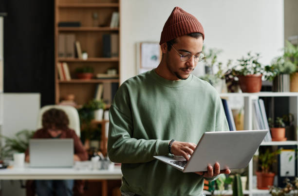 istock Young serious IT support manager answering questions of online users 1439551794