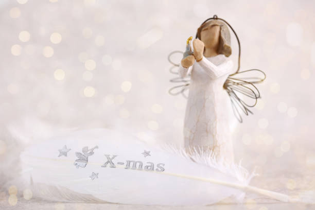istock Christmas time background. White angel and Gentle feather decoration. Copy space 1439555191