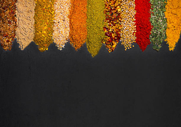 istock Seasoning scattered on a black table, background for food packaging. 1439556316