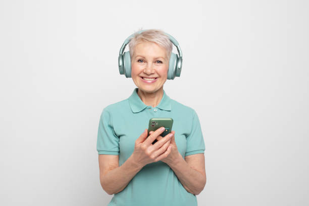 istock Charming pensioner wearing wireless headphones. 1439557972
