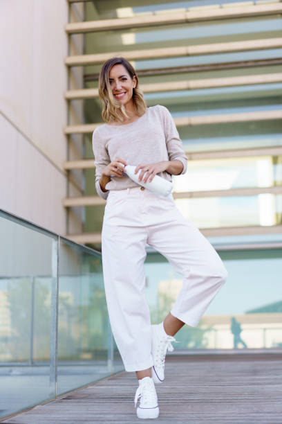 istock Cheerful woman with bottle on path 1439560855