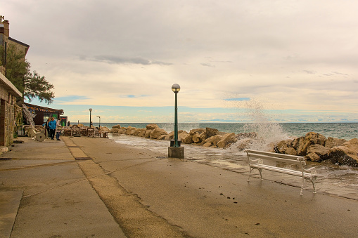 Piran, Slovenia - September 17th 2022. Rough waves and high water on the waterfront of Piran town in Slovenia in mid September