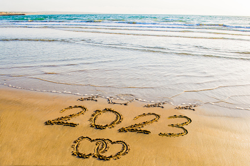 New Year 2023 text on sea beach with love concepts