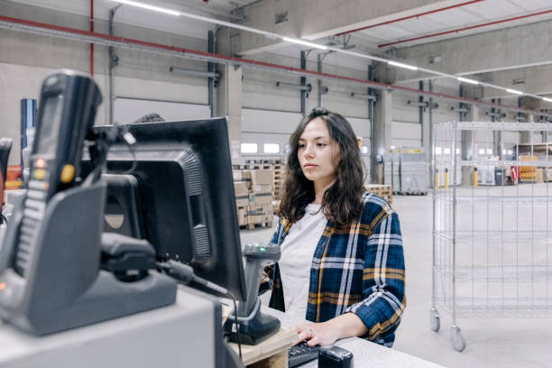 istock Woman checking the shipment status on a computer in distribution warehouse 1439568314