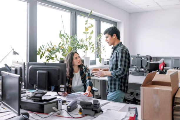 Two people working together in office