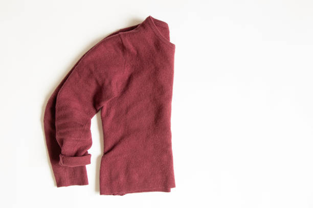 istock Red wool sweater lies on a white background, women's clothes 1439571335