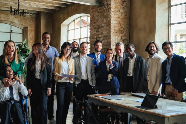 Happy multiracial business people working inside bank office - Focus on center senior woman face Happy multiracial business people working inside bank office - Focus on center senior woman face age contrast stock pictures, royalty-free photos & images