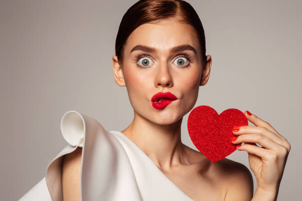 istock Beautiful emotional woman holding present box 1439571487
