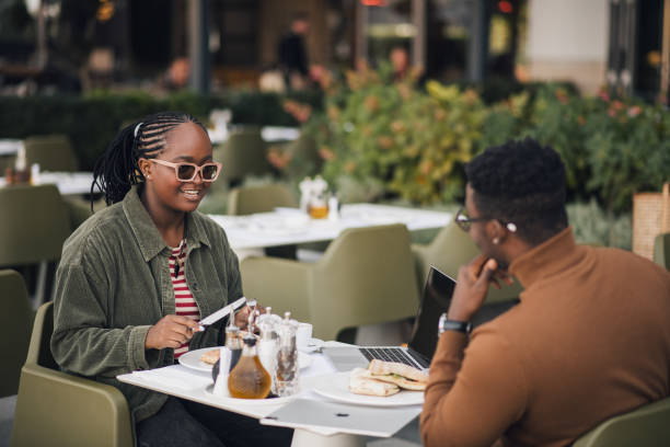 istock Young black couple eating in a restaurant 1439572002