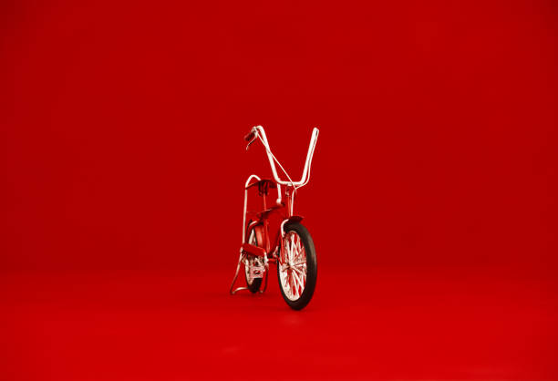 istock Small red bike against a red background with space for text 1439572804