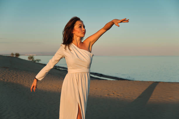 istock Dances in the desert in white dress 1439574258