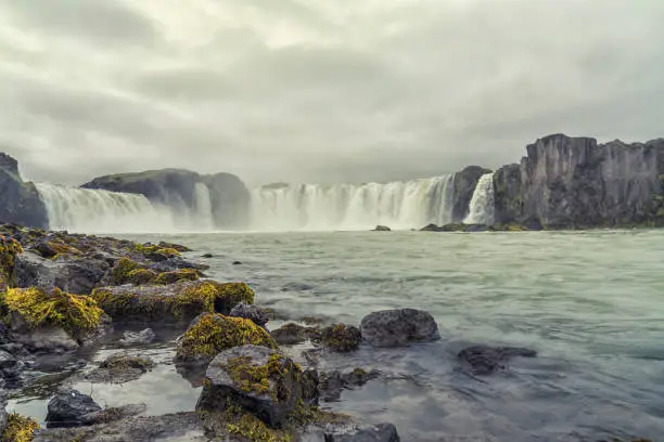 Goðafoss waterfall in Northern Iceland on cloudy day, low angle view.