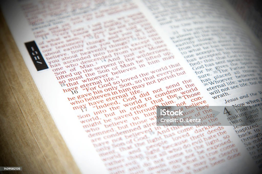 John 3:16 Bible Verse The famous John 3:16 Bible verse, "For God so loved the world that he gave his one and only Son..." isolated by blur effect. Bible Stock Photo