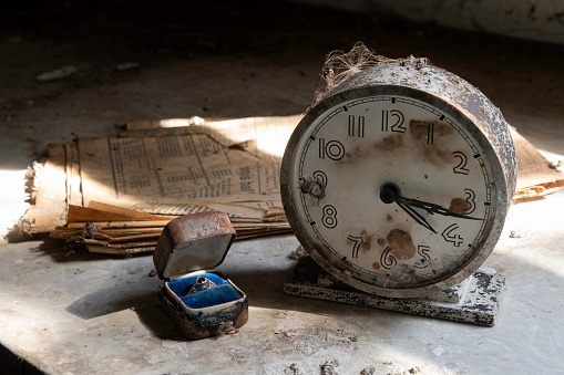 Old clock, ring and newspaper in an abandoned farmhouse in North Dakota