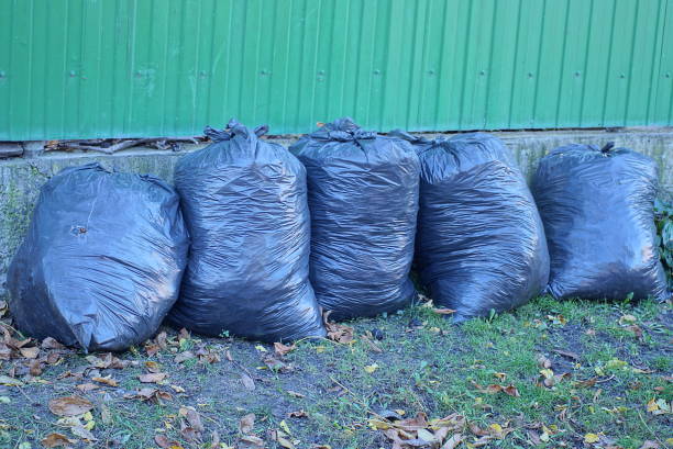 istock a row of black full plastic bags with garbage 1439584538