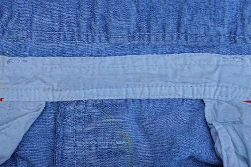 texture of blue cotton fabric with a white stripe seam on clothes