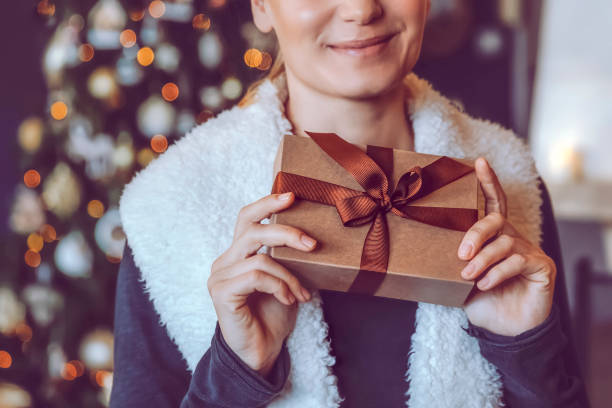istock Happy Woman with Christmas Gift 1439585010