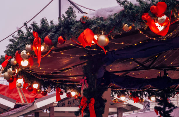 istock Christmas market kiosk with illumination, decorative red bows. 1439587831
