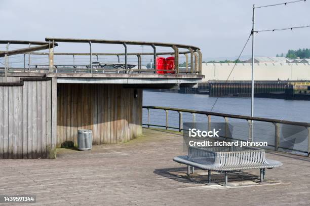 Lonely Empty Bench At The River Clyde In Govan For Mindfulness And Meditation Stock Photo - Download Image Now