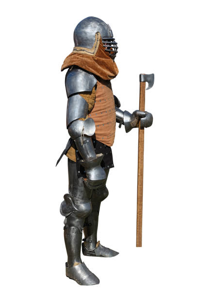 istock Medieval knight in armor stands with a battle axe. 1439592545