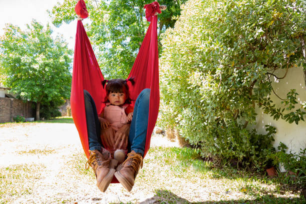 istock mother swinging with her baby 1439593353