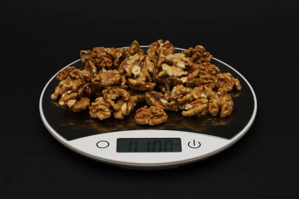 istock Walnut weighing 100 grams on electronic scales. Close-up 1439601767