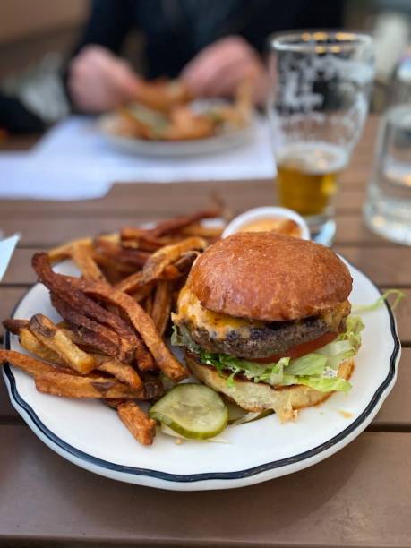 istock Regular Cheeseburger and Fries with a Pickle - Eating Out 1439604595