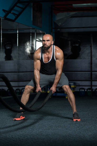 istock Battling Ropes Young Man At Gym Workout Exercise 1439605728