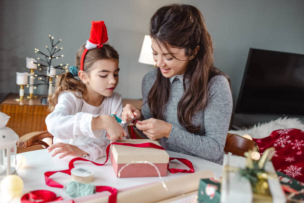 istock Excitement and packing Christmas presents at home 1439606391