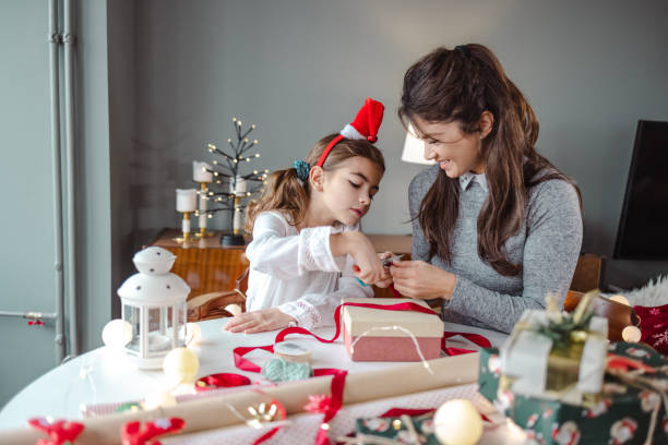 istock Excitement and packing Christmas presents at home 1439606401