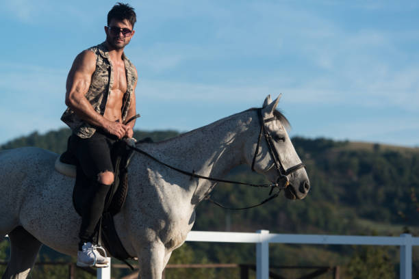 istock Handsome Man With Horse Riding 1439606416