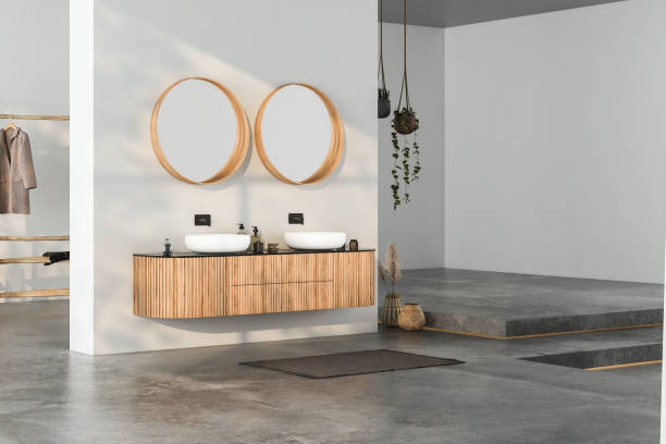istock Modern bathroom interior with concrete floor, two sinks, double mirrors, white bathtub, interior plants, sea view from window.Minimalist bathroom with modern furniture and panoramic view. 3D rendering 1439608731