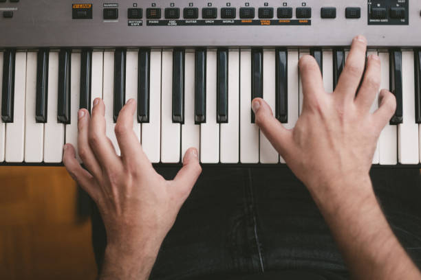 istock High angle view of a pianist playing electronic piano keyboards 1439610725