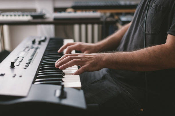 istock Close-Up Of Hands playing electronic piano keyboards 1439610744