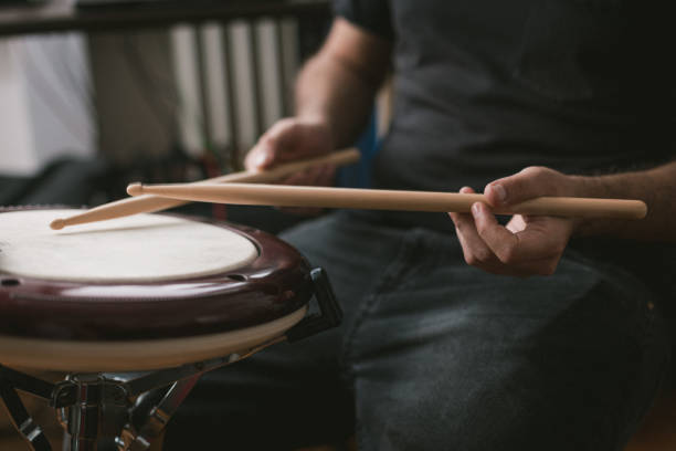 istock Young musician playing wavedrum percussion instrument in home music studio 1439610900
