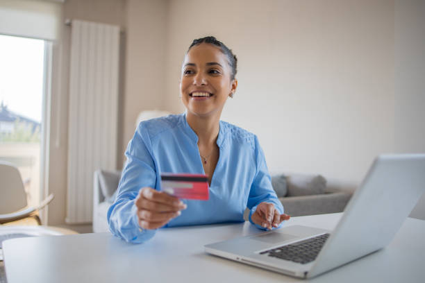 istock Cheerful  woman doing online shopping 1439614476