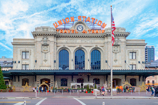 London, England - 20 April 2024: The 19th century facade of Fenchurch Street station  contrasts with the surrounding office blocks. The station is well known for it's inclusion on the UK version of the Monopoly board game.