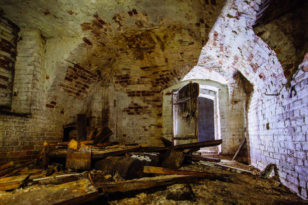 abandoned empty old dark underground vaulted cellar - church indoors inside of monastery imagens e fotografias de stock