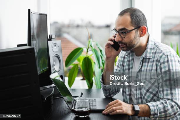 Photo Of A Young Man At His Desktop Computer Doing Computer Programming ...