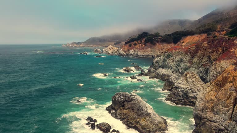 Drone aerial flight view of sapphire sea on the Big Sur Coastline west California next to route 1