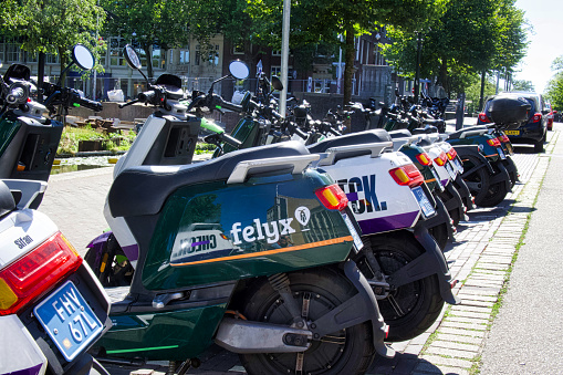 the hague, netherlands - august 09 2022: stand of modern scooter rental and share system on a city street