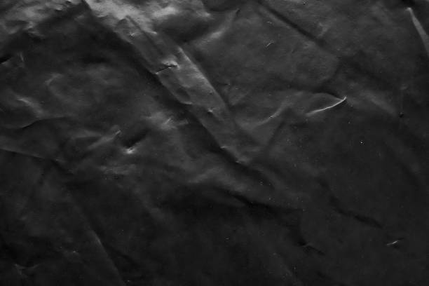 istock transparent plastic bag wrap overlay texture on black background 1439625560