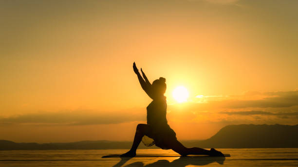 istock Woman silhouette practicing low lunge yoga pose, side view 1439625599