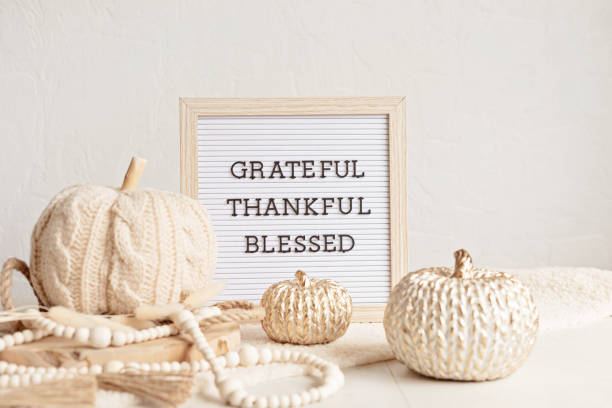 istock Felt letter board and text grateful, thankful, blessed. Autumn table decoration. Floral interior decor for fall holidays with handmade pumpkins 1439625719