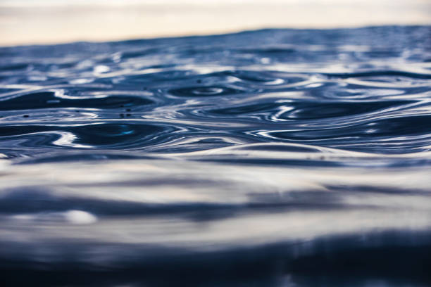 istock Sunrise reflecting over a metallic ocean surface 1439625936